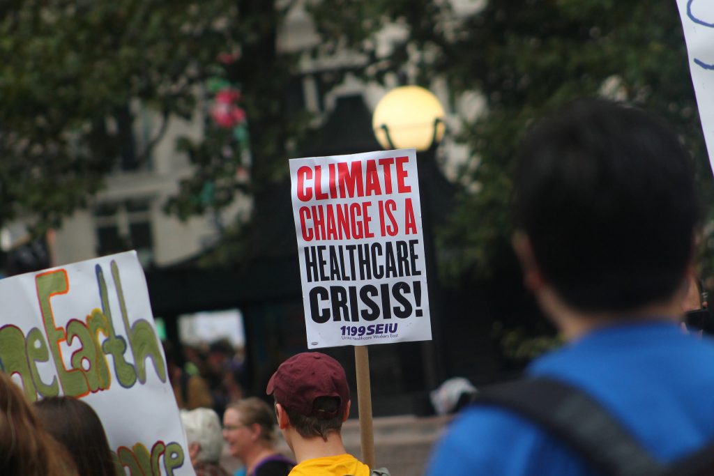 People holding placard for saving climate