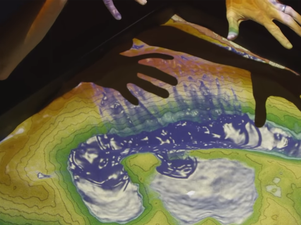 A man using the augmented reality sandbox